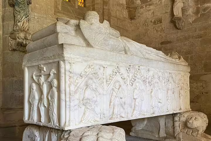 Intricately carved marble tomb inside a historic church in Évora, showcasing medieval artistry on a Lisbon day tour.