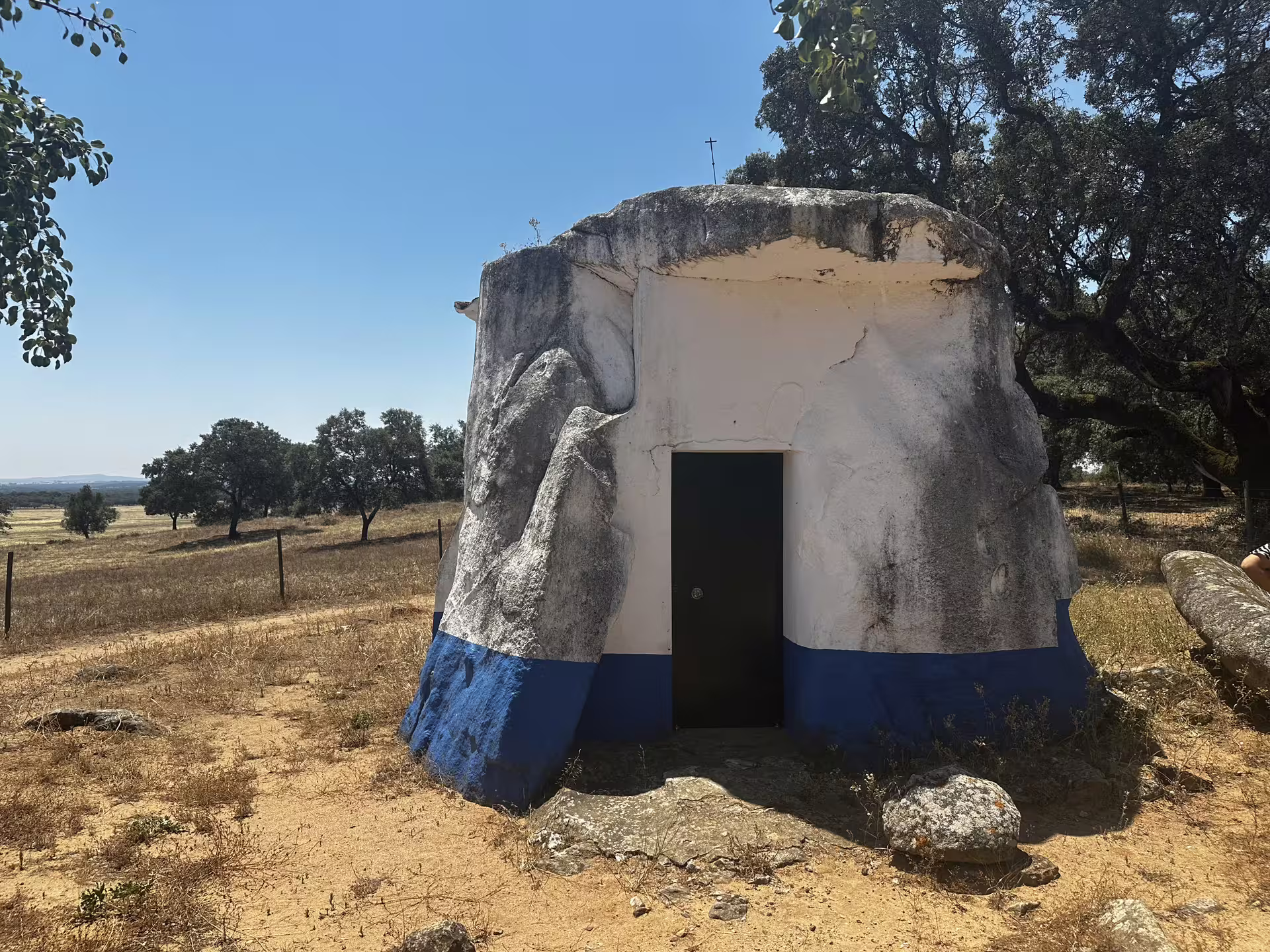 Visit a unique stone and plaster hut amidst the serene landscapes of Évora, a highlight of the megalith tour.