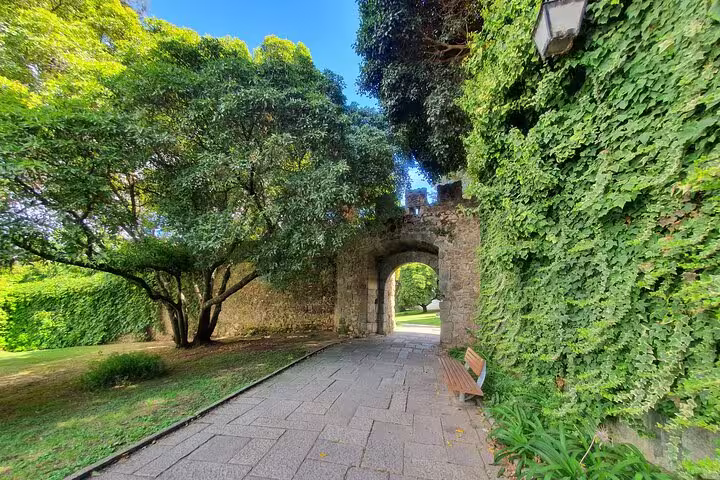 Scenic stone archway surrounded by lush greenery on the Évora & Monsaraz small-group full-day tour from Lisbon.