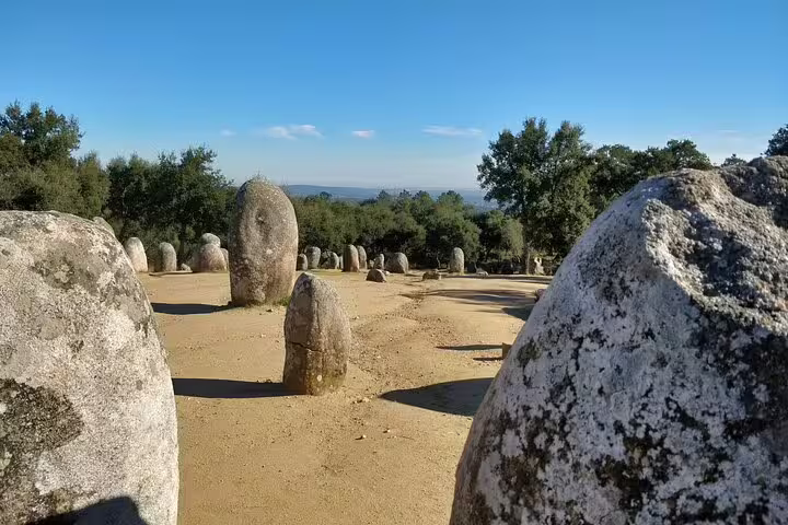 Ancient stone circle under a clear blue sky in Évora, Portugal, showcasing the historic charm of Alentejo on a guided day tour.