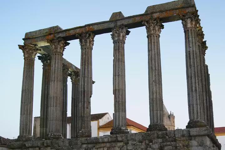 Ancient Roman Temple of Évora's Corinthian columns against a clear sky, a highlight of the Lisbon to Évora full-day tour.