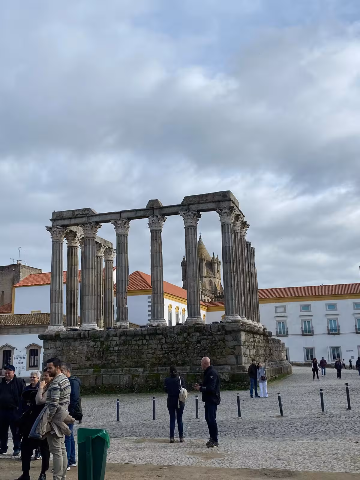 Tourists explore the Roman Temple of Évora, a key historical site on a private cultural and wine tour.