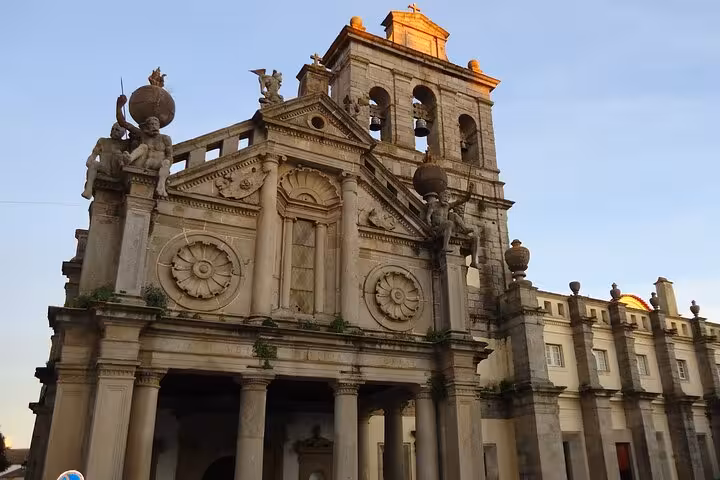 Stunning view of Évora's Roman temple at sunset, showcasing intricate architecture on a private walking tour.
