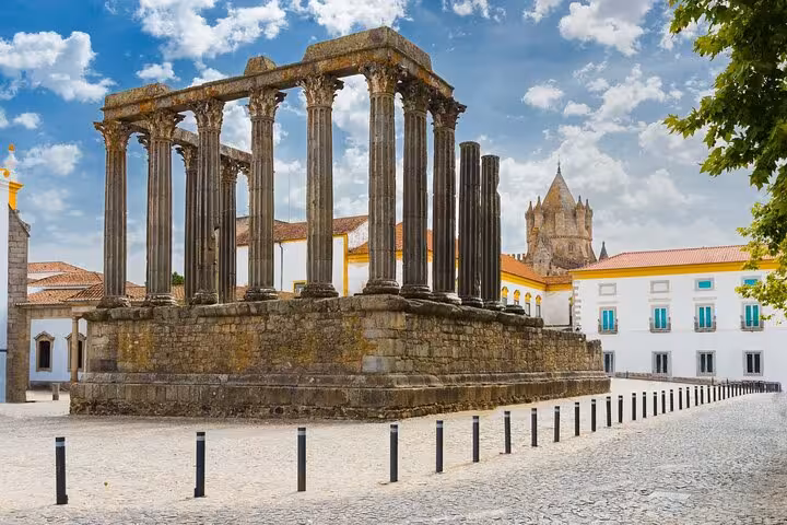 Ancient Roman Temple in Évora under a bright sky, a highlight of the small group walking tour with Chapel of Bones.