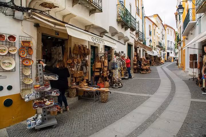 Charming street in Évora with local shops and vibrant architecture, perfect for a small group walking tour experience.