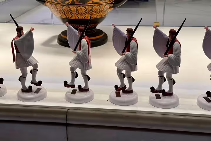 Evzones guard figurines in Athens museum display, cultural stop on Acropolis and city highlights private tour