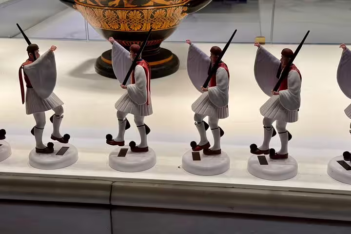 Evzones guard figurines in Athens museum display, cultural stop on a 2-hour private express Athens highlights tour