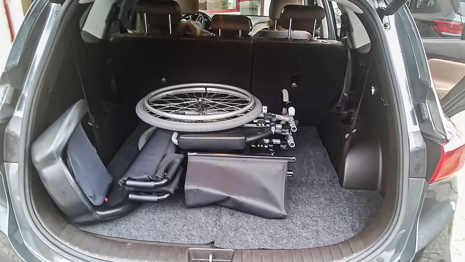 Spacious executive car trunk with folded wheelchair, highlighting accessibility and convenience for private chauffeur service.