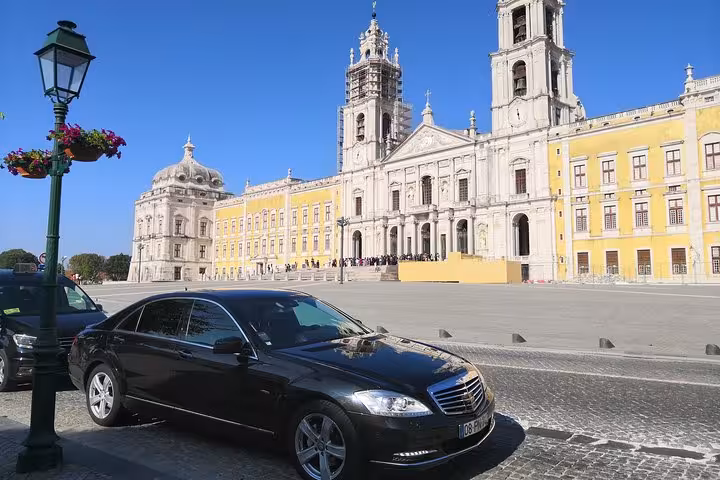 Executive Lisbon airport shuttle vehicle near Jeronimos Monastery, reliable Lisbon city transfer or return