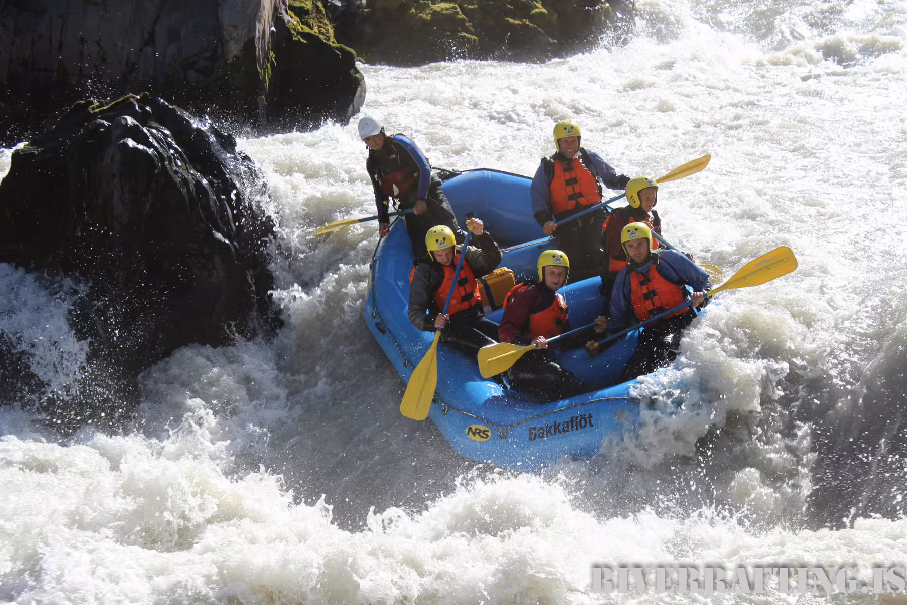 Thrill-seekers navigate intense rapids on a guided extreme river rafting adventure, showcasing teamwork and adrenaline in wild waters.