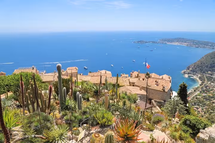 Picturesque view of Eze village with lush gardens and panoramic sea views, capturing the charm of the French Riviera.