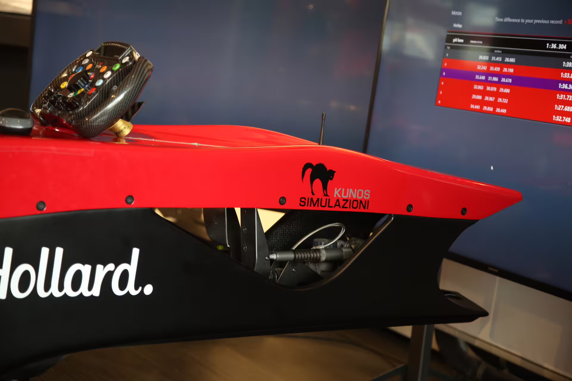 Detailed view of F1 simulator with racing wheel and performance stats at Museo Ferrari, offering a thrilling Maranello adventure.