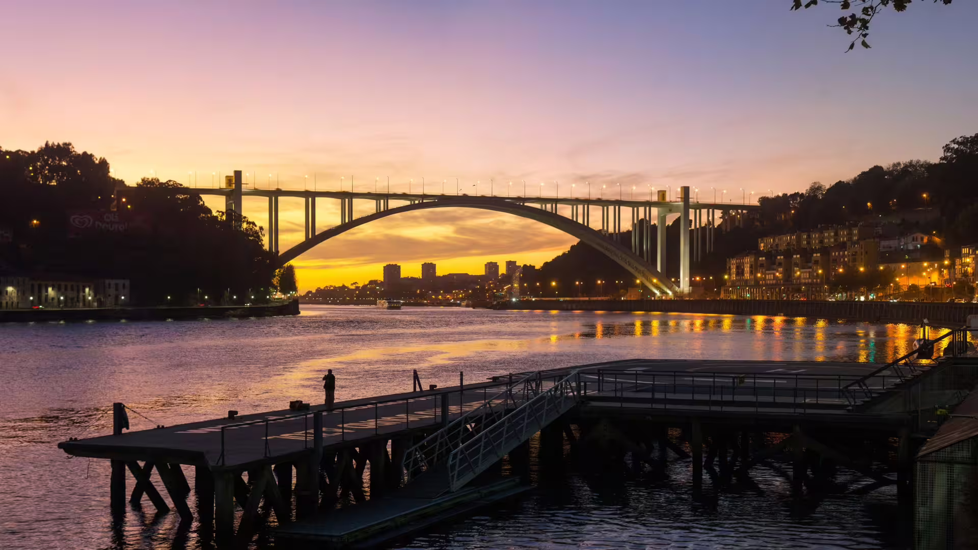 Closer view of the Douro River sunset and the Arrabida Bridge in Porto, part of Cooltour Oporto's Night Tour