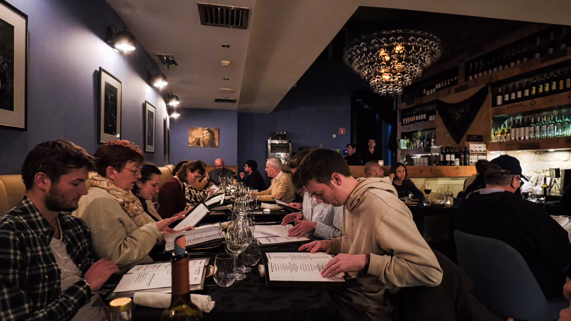 Image of guests at the restaurant choosing their menus before the Fado show, part of Cooltour Oporto's Fado Dinner Show with Night Tour 