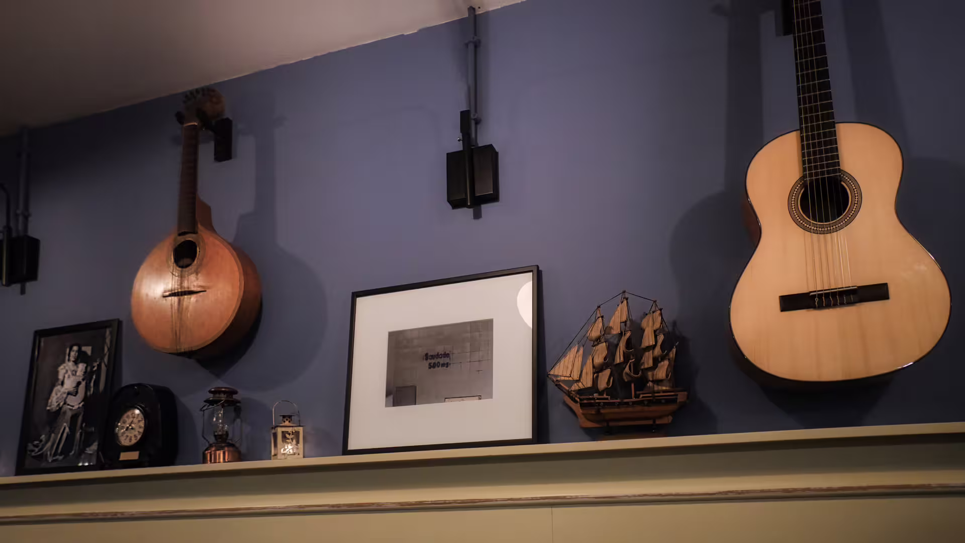 Image of a local restaurant in Porto showcasing Portuguese and Classic guitars on its wall, part of Cooltour Oporto's Fado Dinner Show 