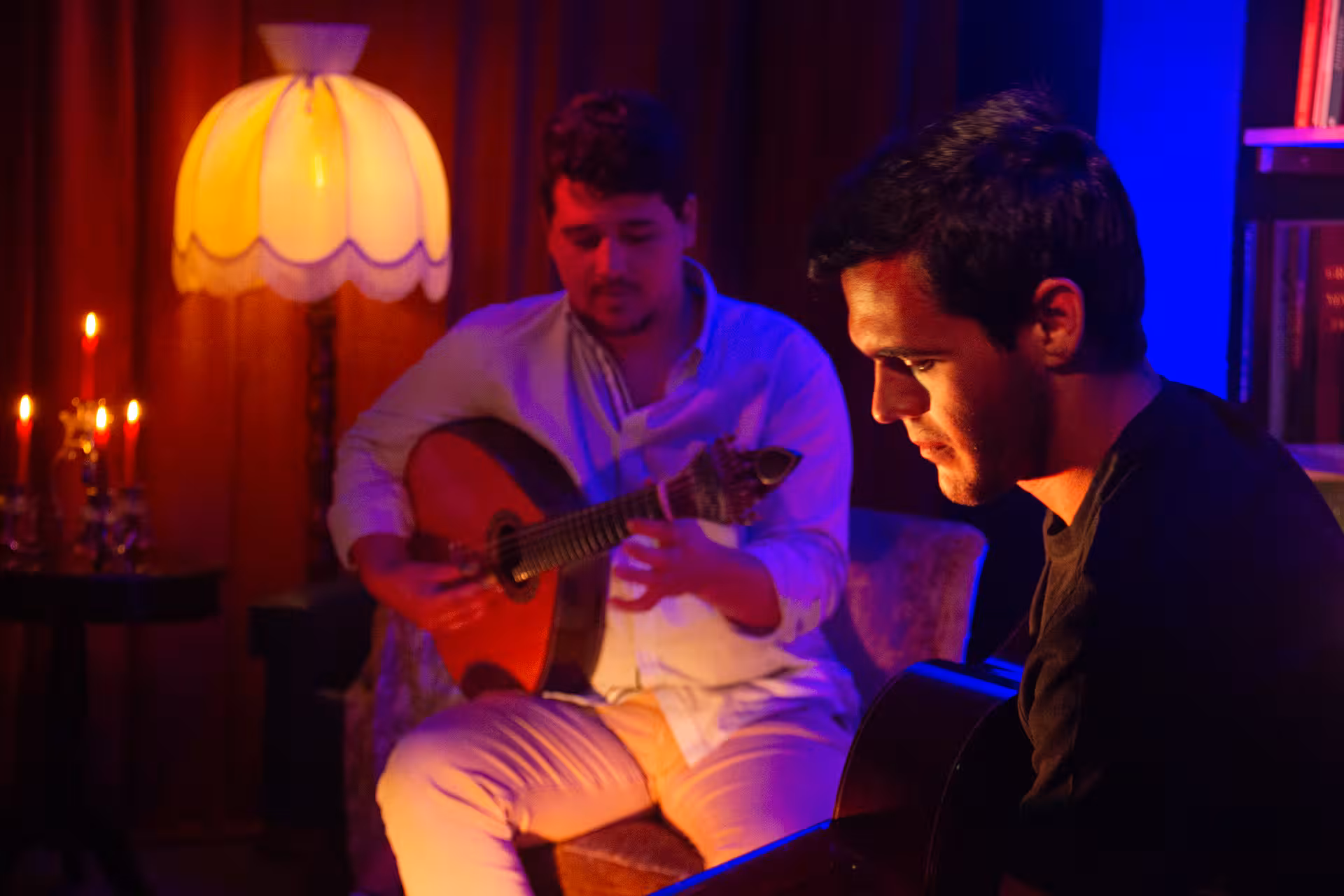 Musicians immersed in playing Fado music, illuminated by warm lighting, creating an authentic Portuguese atmosphere.