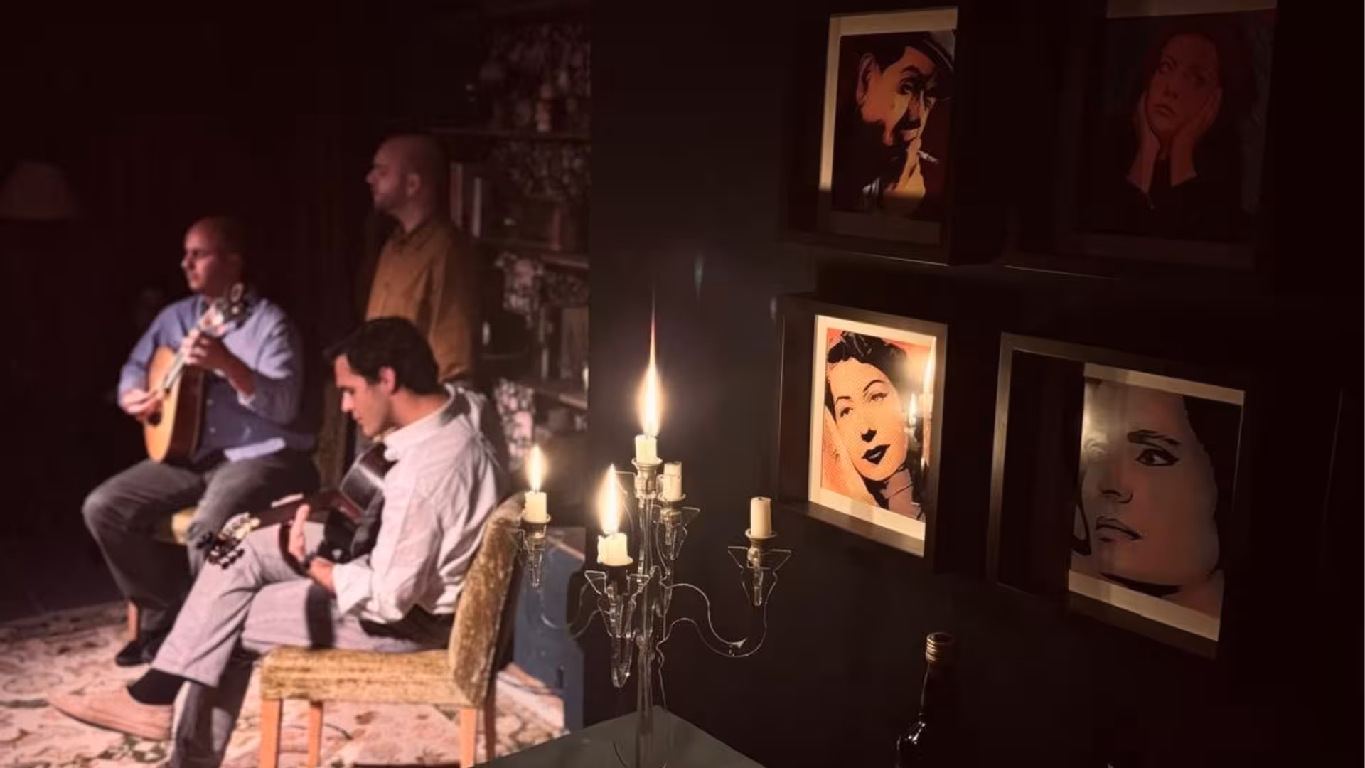 Intimate Fado performance with musicians playing guitars by candlelight, creating a cozy Portuguese ambiance.