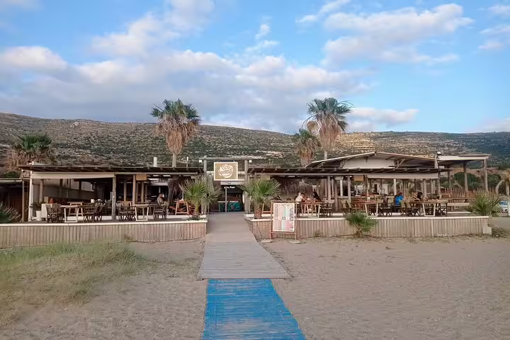 Charming beachfront cafe at Falasarna Beach, perfect for relaxing during a sunset tour in Crete, Greece.