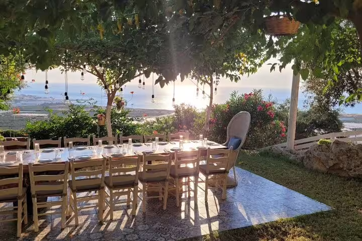 Elegant dining area with ocean views bathed in golden sunset light at Falasarna Beach.