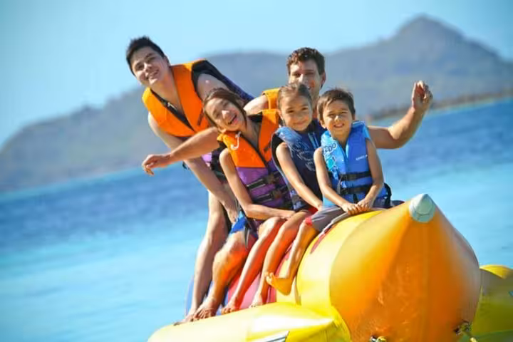 Family riding a banana boat in Sharm El Sheikh, Red Sea water fun included in shared sea activities package