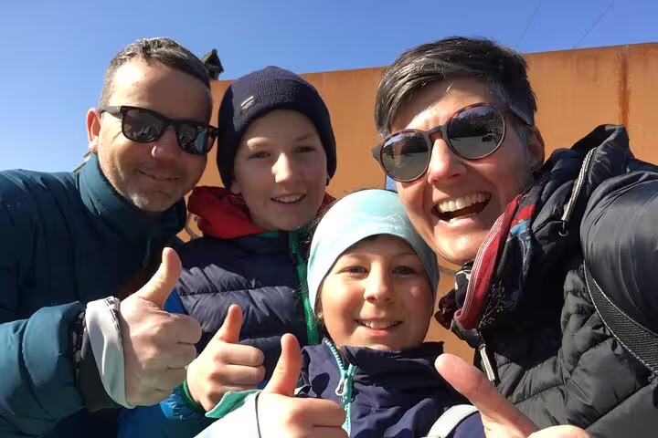 Happy family giving thumbs up on a Bern self-guided scavenger hunt tour, exploring city sights together