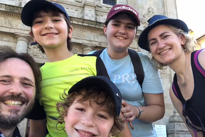 Family group selfie at a historic Braga church facade during a self-guided scavenger hunt and sightseeing tour