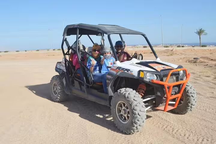 Family riding a double buggy on Sharm El Sheikh desert safari tour, Red Sea coast dunes and off-road fun