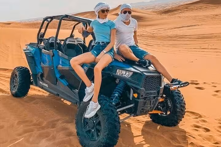 Couple riding a family buggy across Sharm El Sheikh sand dunes on a Red Sea desert adventure tour