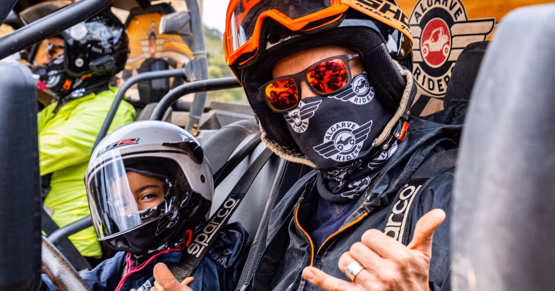Smiling family in helmets and goggles ready to ride on a safe, guided half-day Algarve buggy tour through scenic countryside