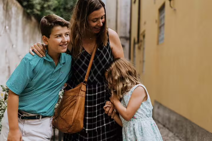 Family candid in a charming Lake Como village lane, photographed on a private tour with local photographer