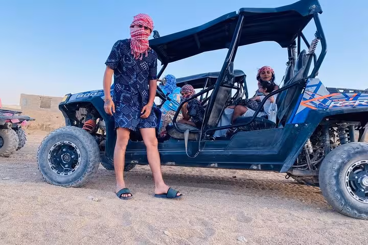 Family car buggy in Sharm El Sheikh desert with riders in scarves, ready for a safe off-road tour
