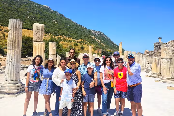 Family on private Ephesus tour from Bodrum posing among ancient columns, full-day guided trip in Turkey