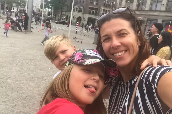 Family selfie in Lille city center during an e-scavenger hunt, exploring landmarks with a mobile game