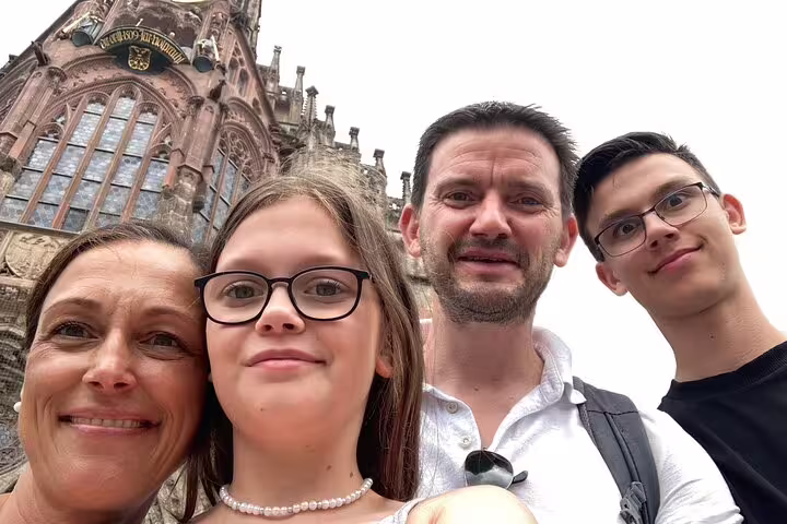 Family selfie at Frauenkirche on Nuremberg scavenger hunt and sights self-guided walking tour
