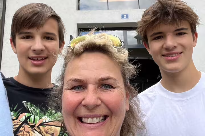 Happy family selfie starting the Fribourg scavenger hunt self-guided tour near the old town sights
