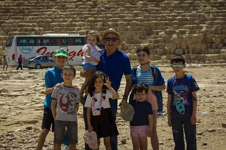 Family group photo at the Giza Pyramids on a 2-day Ancient Egypt tour with pyramids and museum visits