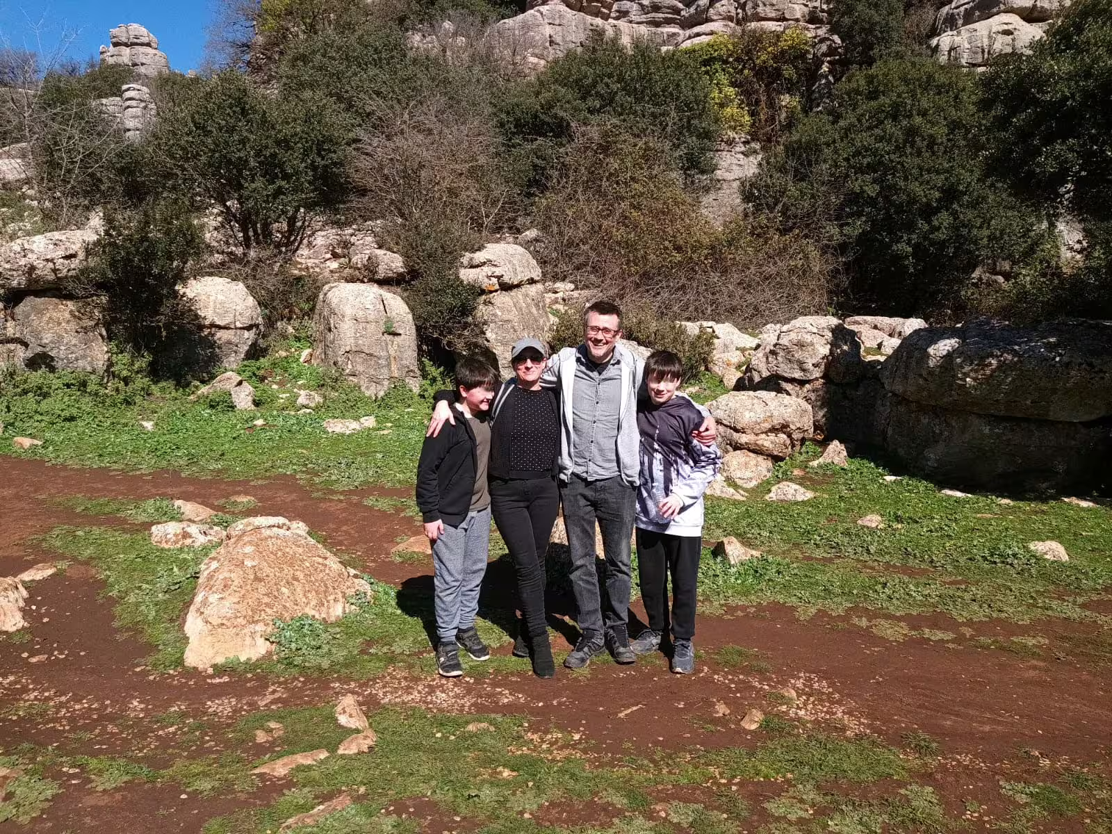 Family group photo on El Torcal hiking trail, part of a private Antequera day trip from Costa del Sol
