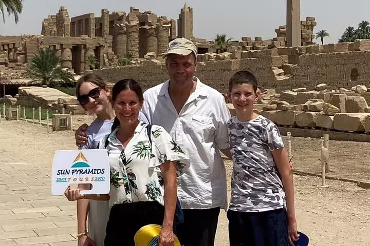 Family group photo at Karnak Temple ruins on a private Luxor day tour from Hurghada by car with guide