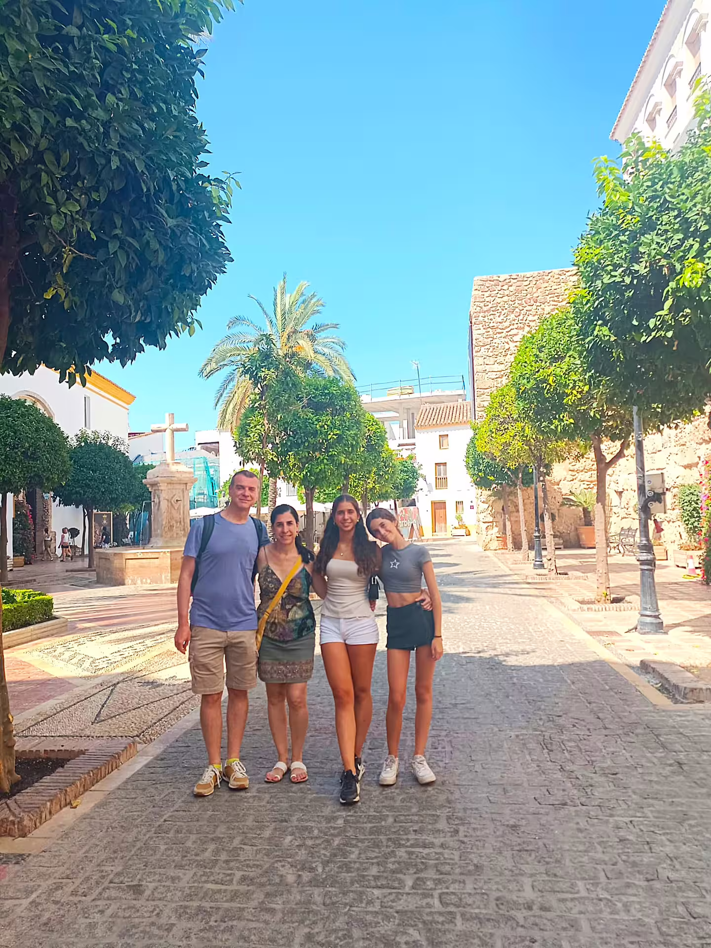 Family photo on a sunny Marbella Old Town street, private Marbella and Puerto Banus day trip with hotel pick-up