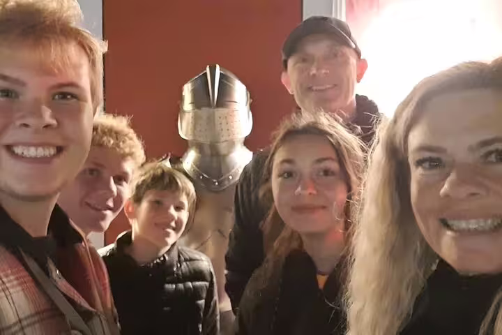 Family selfie by medieval knight armor on Rothenburg self-guided scavenger hunt and sights tour