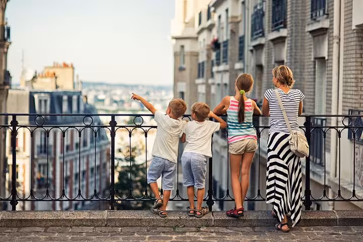 Family enjoying a Montmartre viewpoint in Paris before a street art walking tour and French drink tasting experience