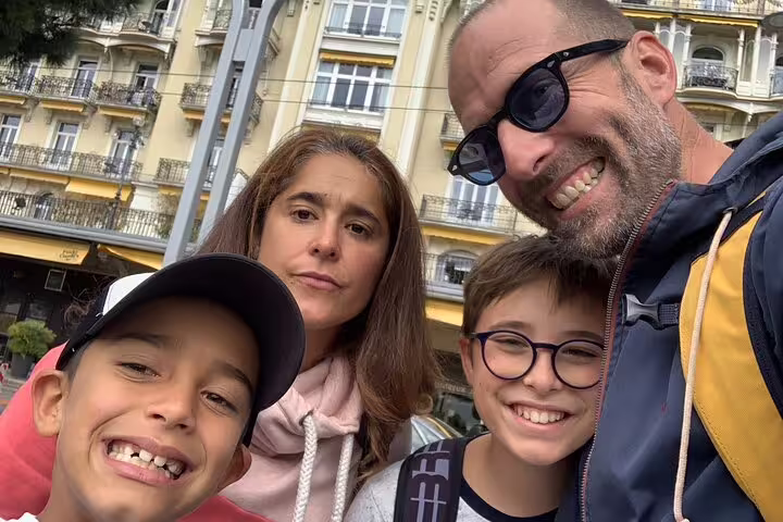 Family selfie in Montreux city center during self-guided scavenger hunt tour, exploring Swiss Riviera sights