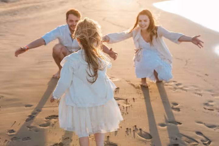 Family enjoys a playful moment on Heraklion beach during a private photoshoot, capturing warm, joyful memories.