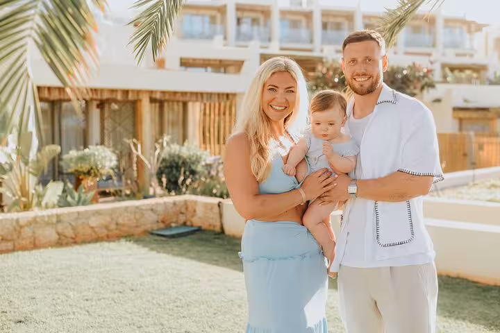 Smiling family posing in a lush garden setting during a private photoshoot in Heraklion.