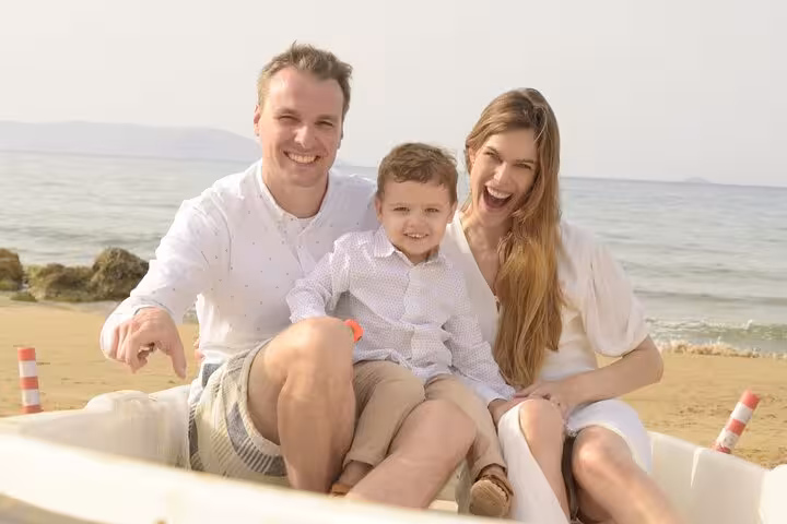 Joyful family enjoying a private photoshoot on a serene Hersonissos beach, perfect for capturing cherished moments.