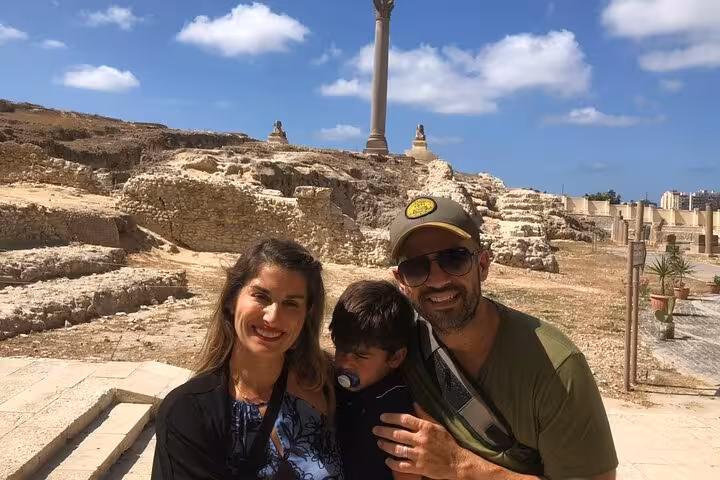 Family at Pompey’s Pillar ruins on a private historical guided day tour to Alexandria from Cairo