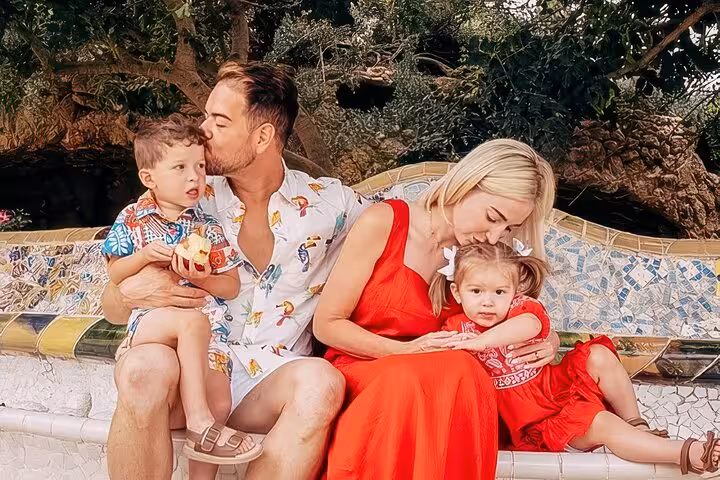 Family portrait on Park Güell’s colorful Gaudí mosaic bench, Timeless Barcelona photoshoot capturing moments in Gràcia.