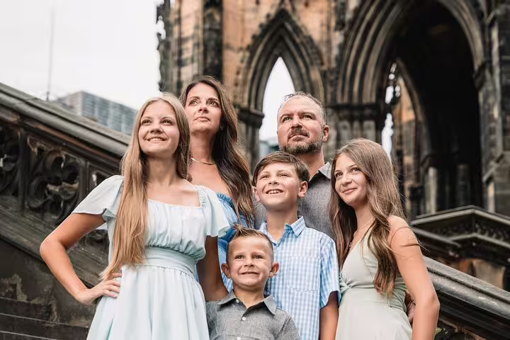 Family portrait at Scott Monument arches during private Edinburgh photoshoot with professional photographer