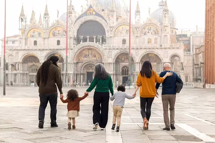 Family walking in St Mark’s Square Venice during a city portrait session with iconic basilica backdrop
