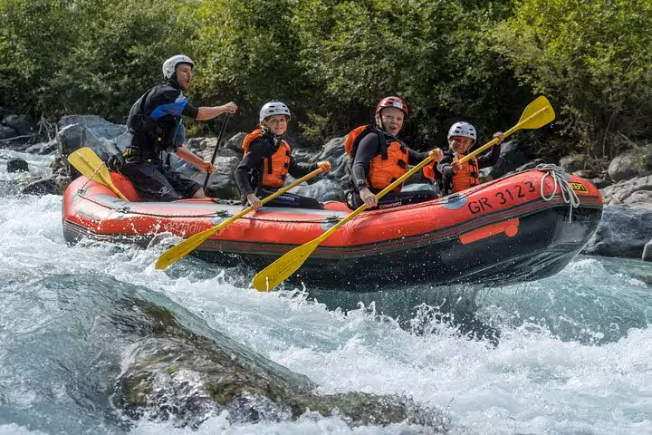 Family enjoying thrilling rafting adventure in Engadin's rapids, perfect for exciting outdoor experiences.